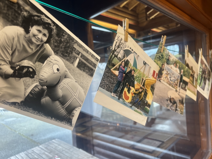 A selection of old photos pegged onto a line as part of an exhibition